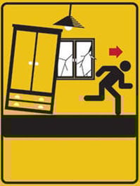 Dibuix d'una persona amagant-se sota una taula. Durant un terratrèmol, és important protegir-se i mantenir la calma.